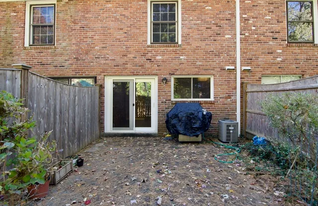 a view of a backyard with potted plants and wooden fence