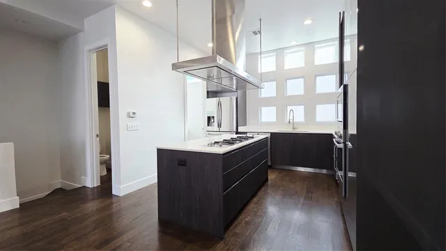 a kitchen with stainless steel appliances granite countertop a stove and a refrigerator