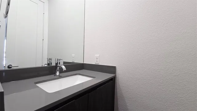 a close up of a mirror and a sink