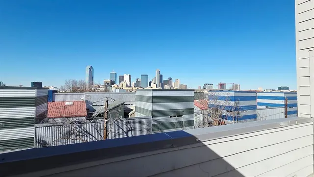 a room with furniture a rug and a view of kitchen