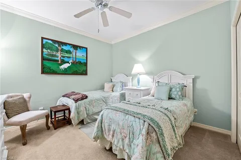 a bedroom with two beds and a chandelier