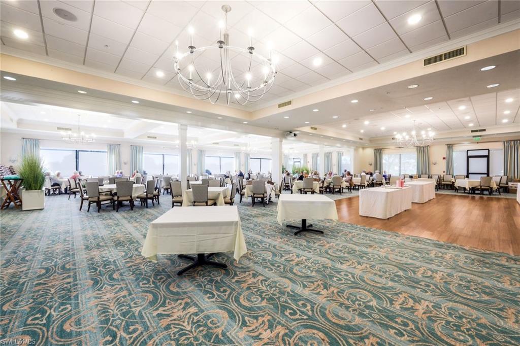 26450 Sunderland Drive, Unit 2102 Bonita Springs, FL 34135 - Photo 25 of 42 a room with lots of chairs and chandelier