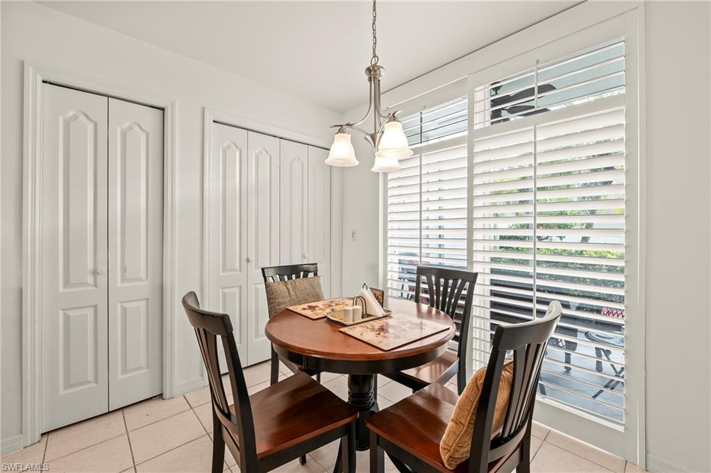 26450 Sunderland Drive, Unit 2102 Bonita Springs, FL 34135 - Photo 3 of 42 a view of a dining room with furniture and window