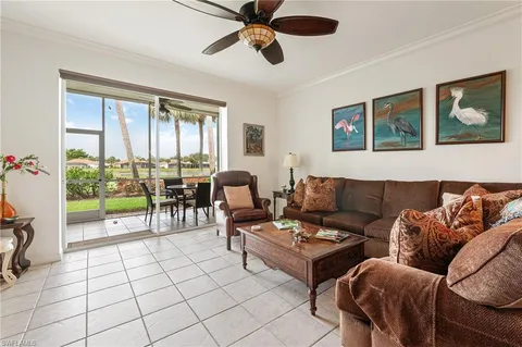 a living room with furniture and a floor to ceiling window