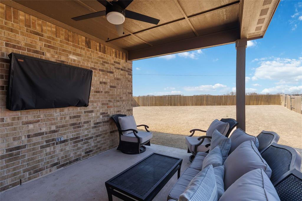1012 Calhoun Drive Anna, TX 75409 - Photo 35 of 39 Covered patio with a ceiling fan, concrete flooring, and an expansive backyard area