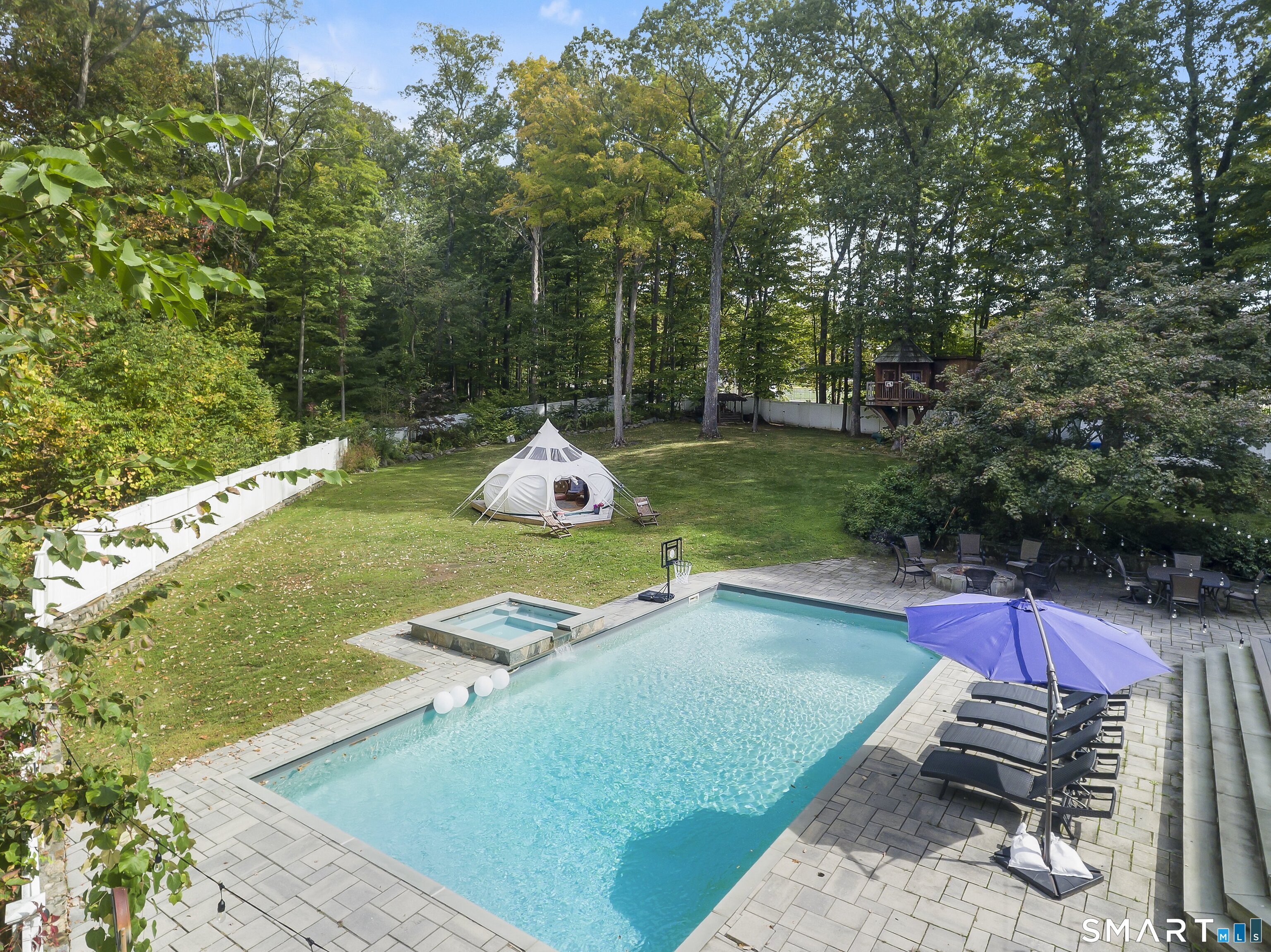 205 Weston Road Weston, CT 06883 - Photo 20 of 21 a view of a wooden deck with chairs and floor to ceiling window