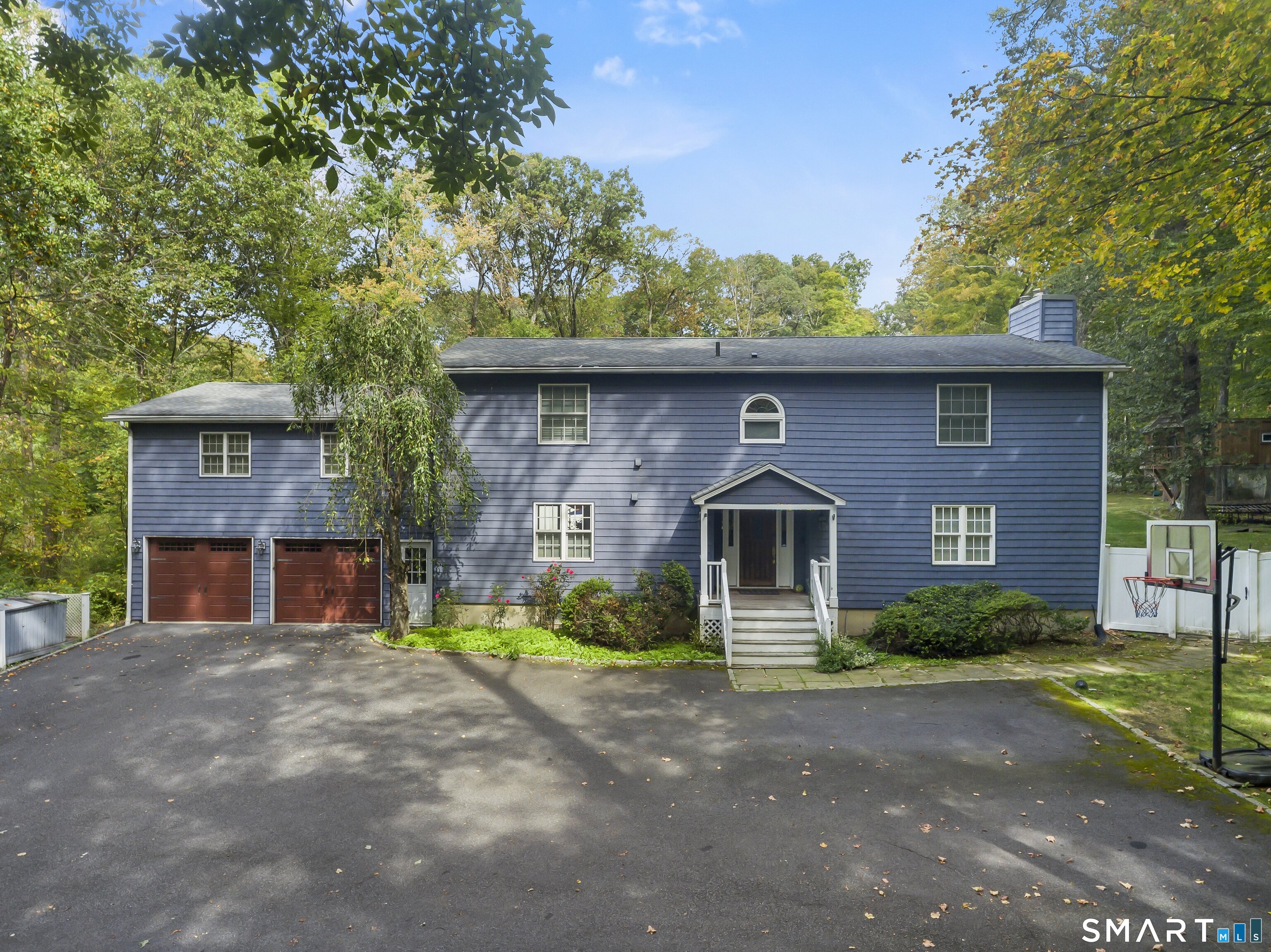 205 Weston Road Weston, CT 06883 - Photo 2 of 21 a front view of a house with a garden