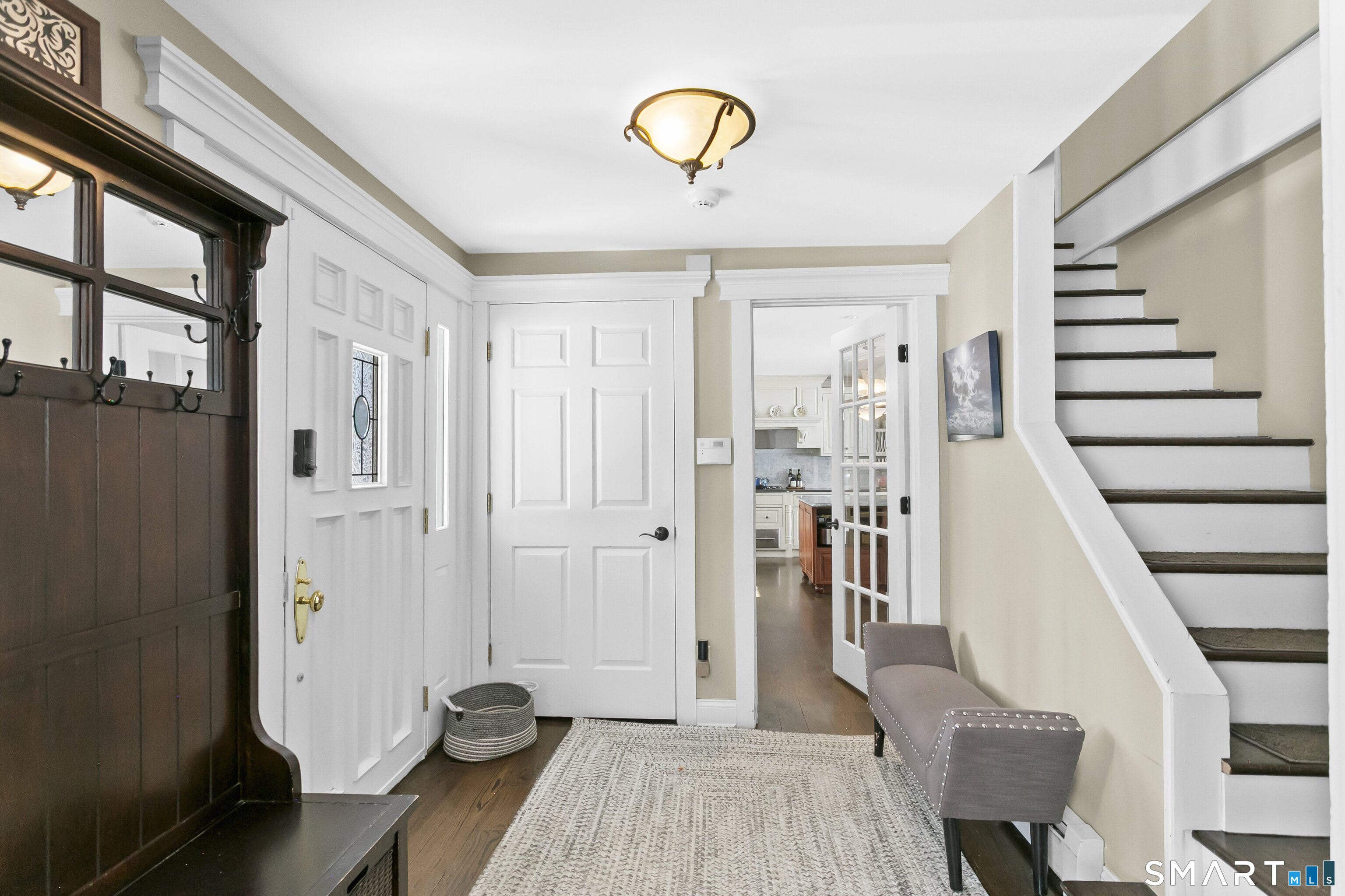 205 Weston Road Weston, CT 06883 - Photo 3 of 21 a view of a hallway with wooden floor and staircase