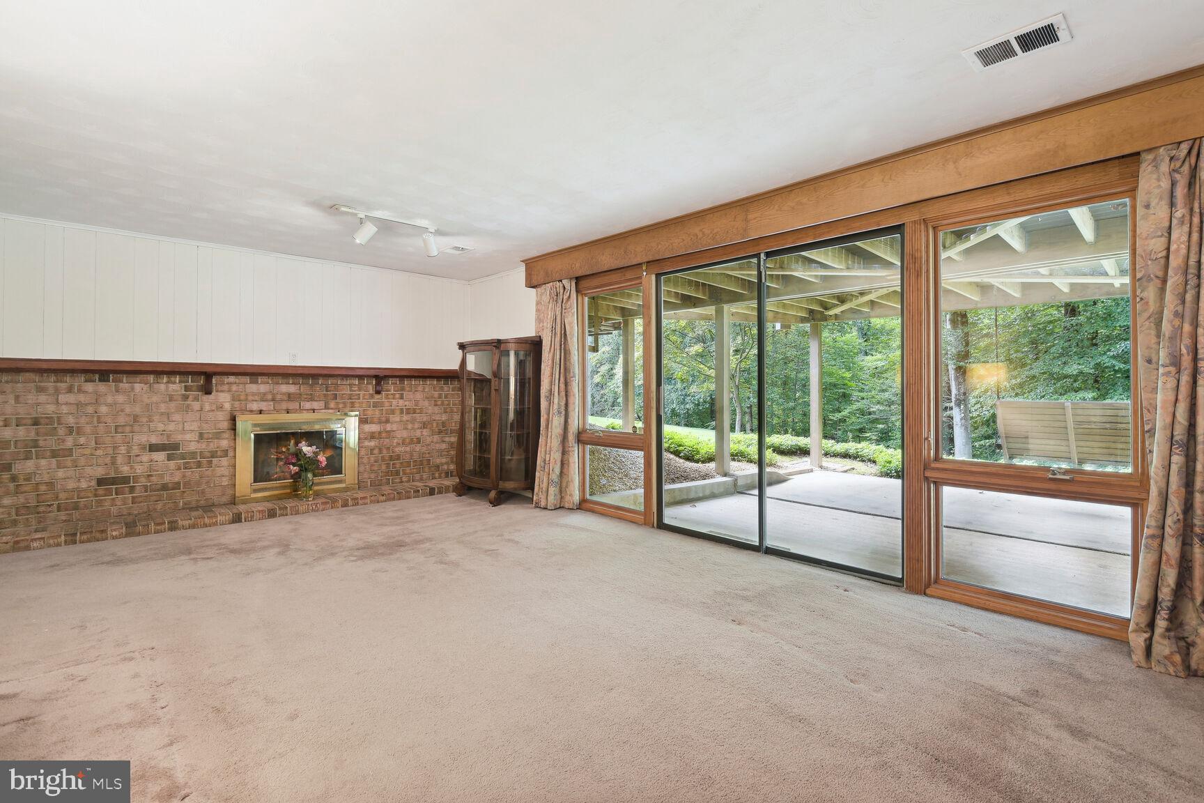 5210 Russett Road Rockville, MD 20853 - Photo 18 of 28 a view of an empty room with fireplace and a window