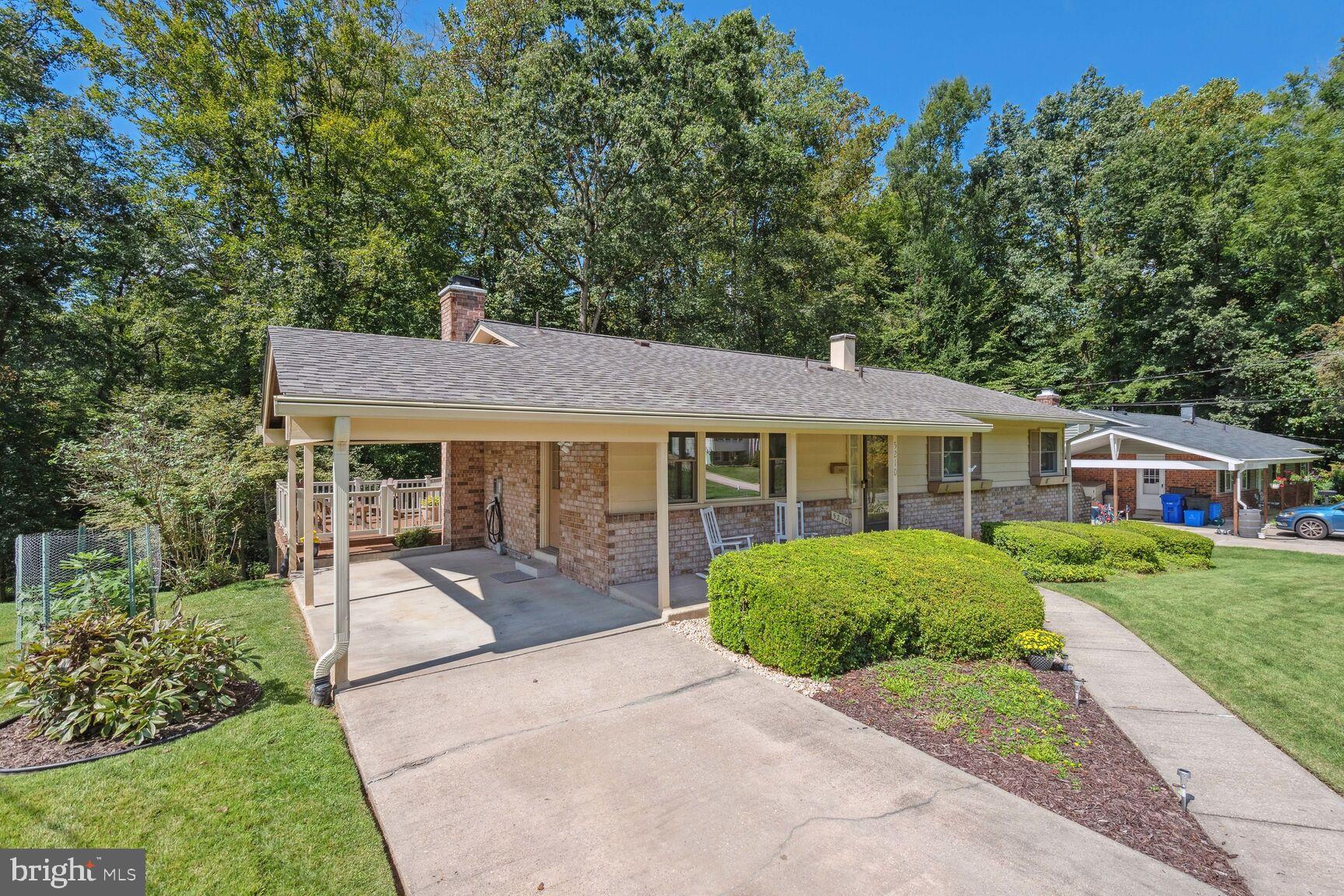 5210 Russett Road Rockville, MD 20853 - Photo 2 of 28 a front view of a house with a yard garden and outdoor seating