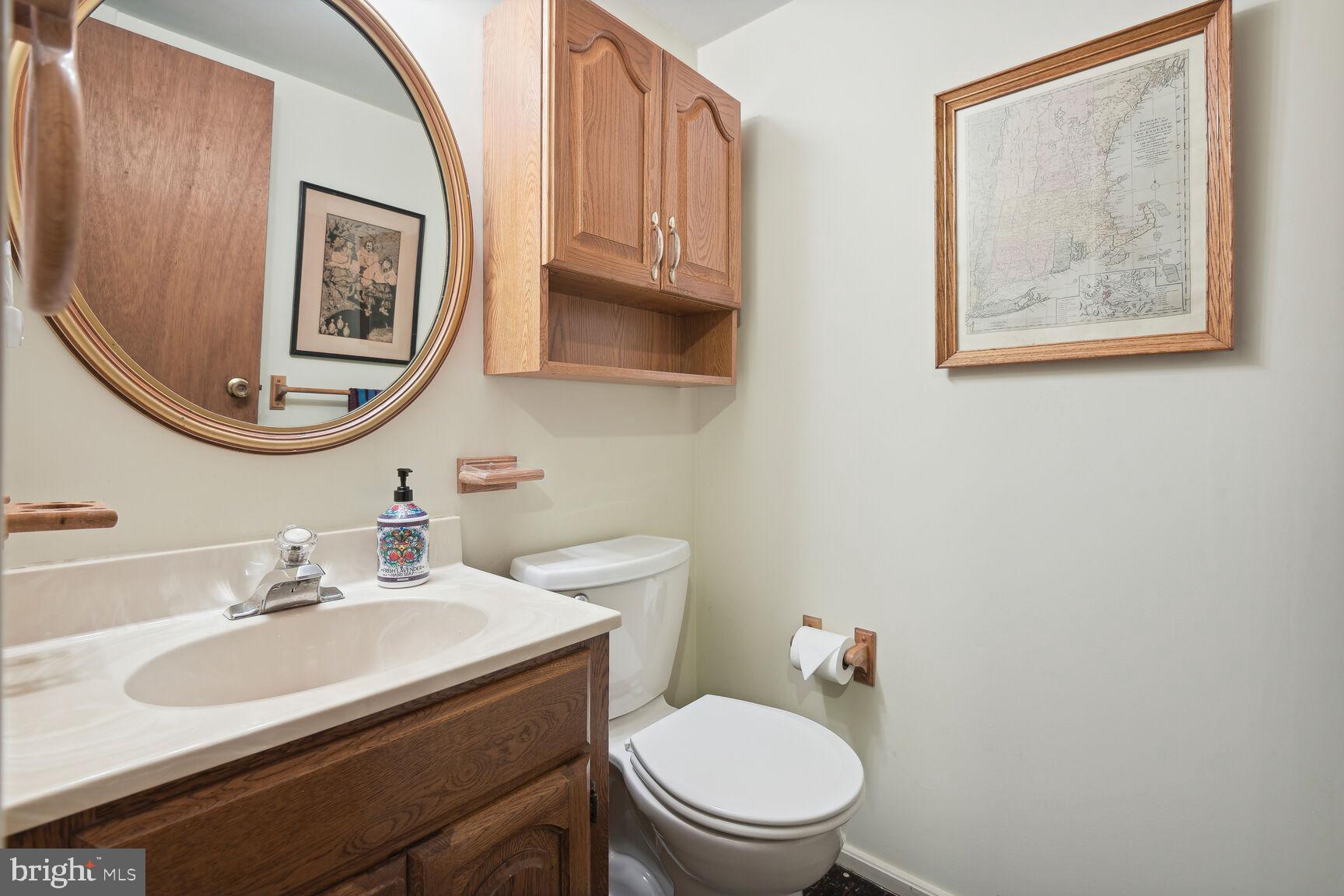 5210 Russett Road Rockville, MD 20853 - Photo 21 of 28 a bathroom with a toilet a sink and mirror