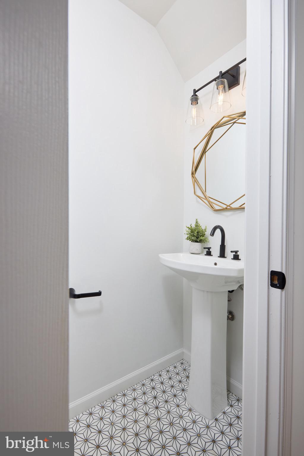 255 14th Street Southeast, Unit A Washington, DC 20003 - Photo 11 of 28 a bathroom with a sink a mirror and vanity