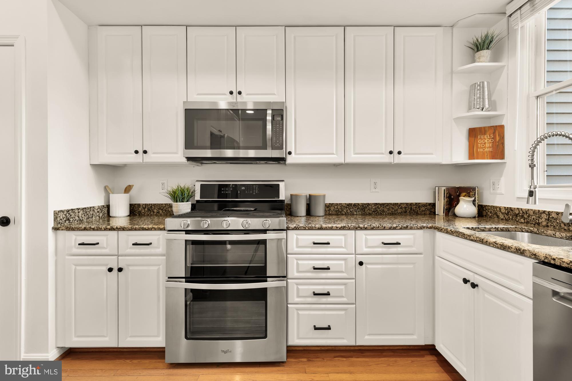 255 14th Street Southeast, Unit A Washington, DC 20003 - Photo 6 of 28 a kitchen with stainless steel appliances granite countertop a stove a sink and white cabinets
