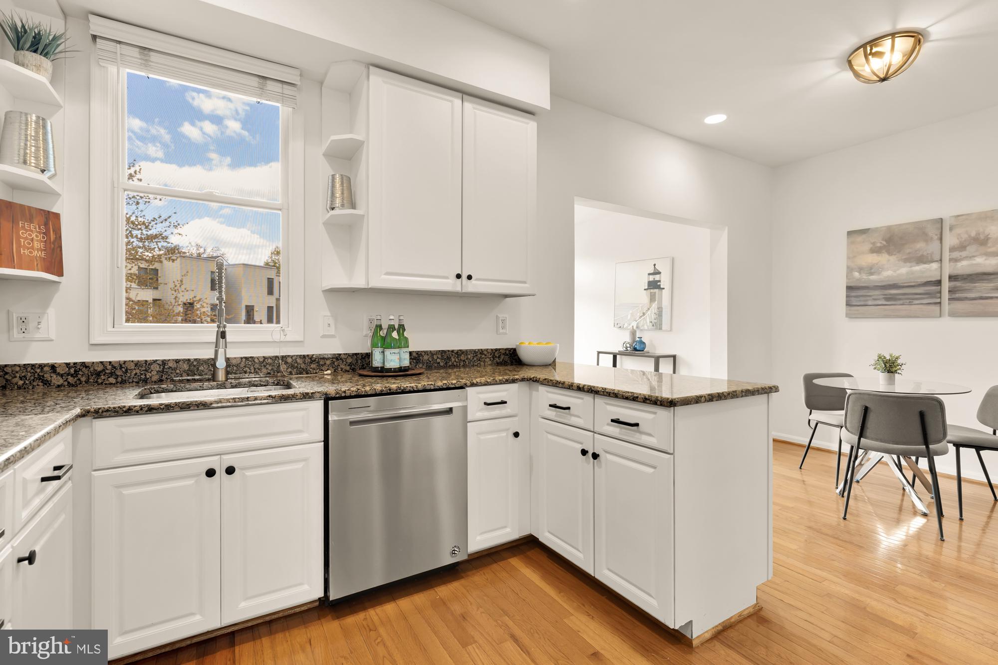 255 14th Street Southeast, Unit A Washington, DC 20003 - Photo 7 of 28 a kitchen with granite countertop white cabinets and white appliances