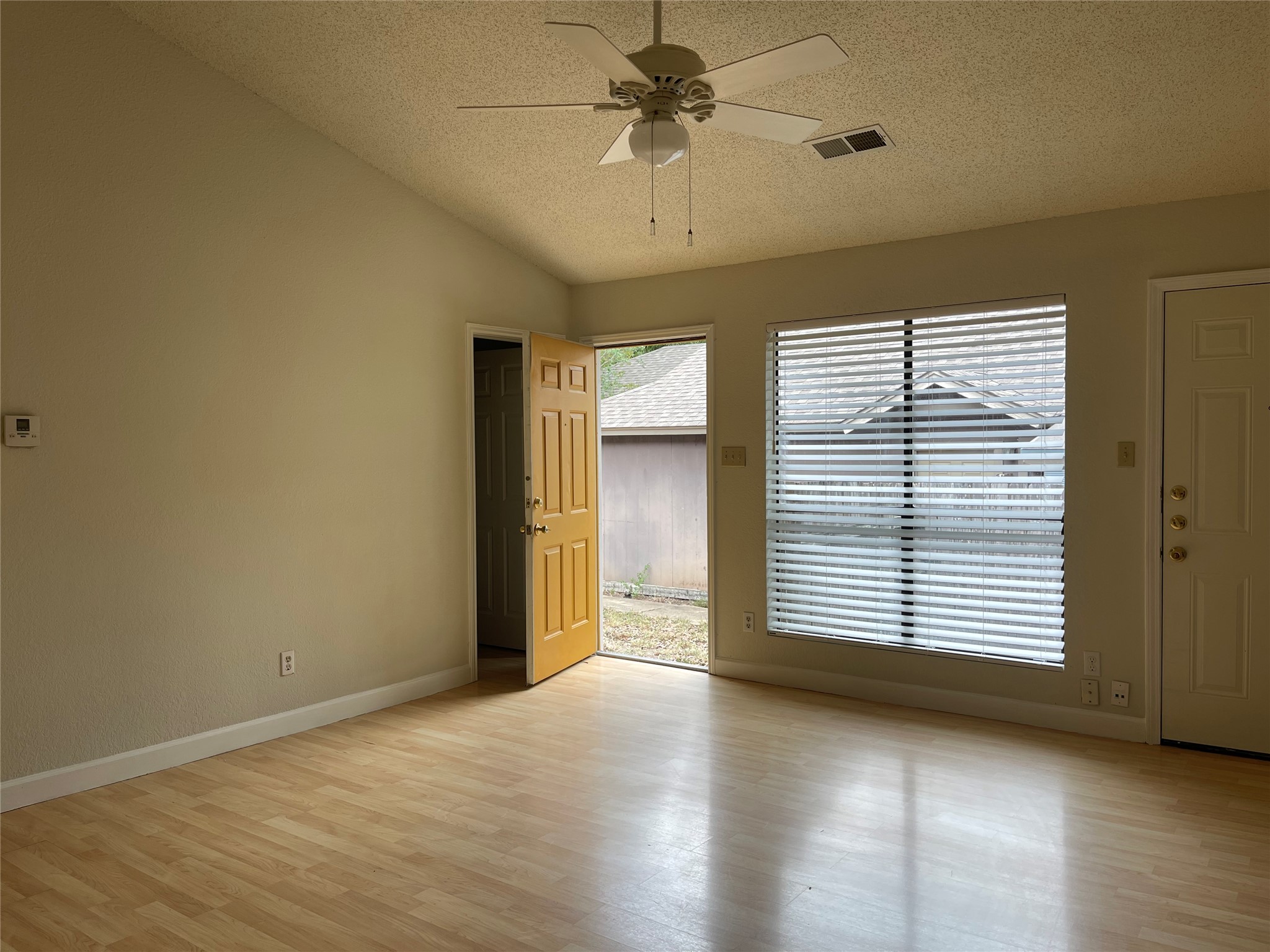 2031 Redwing Way Round Rock, TX 78664 - Photo 4 of 25 A comfortable living space featuring a ceiling fan and light wood flooring.
