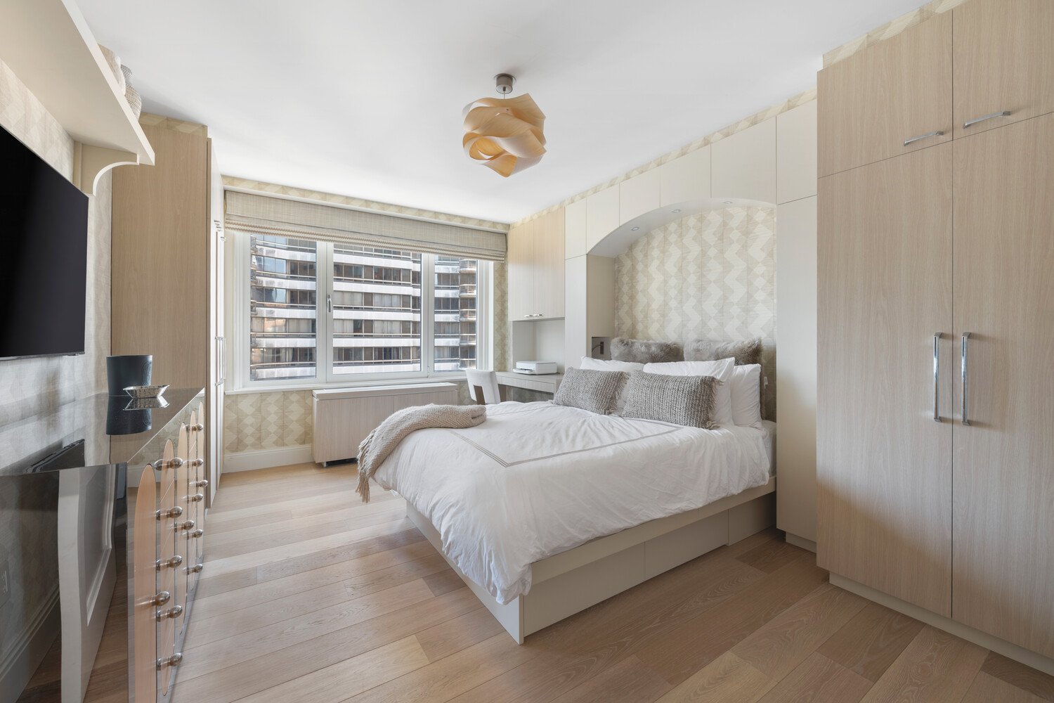 200 East 62nd Street, Unit 19D Manhattan, NY 10065 - Photo 10 of 14 a bed room with a bed window and a television