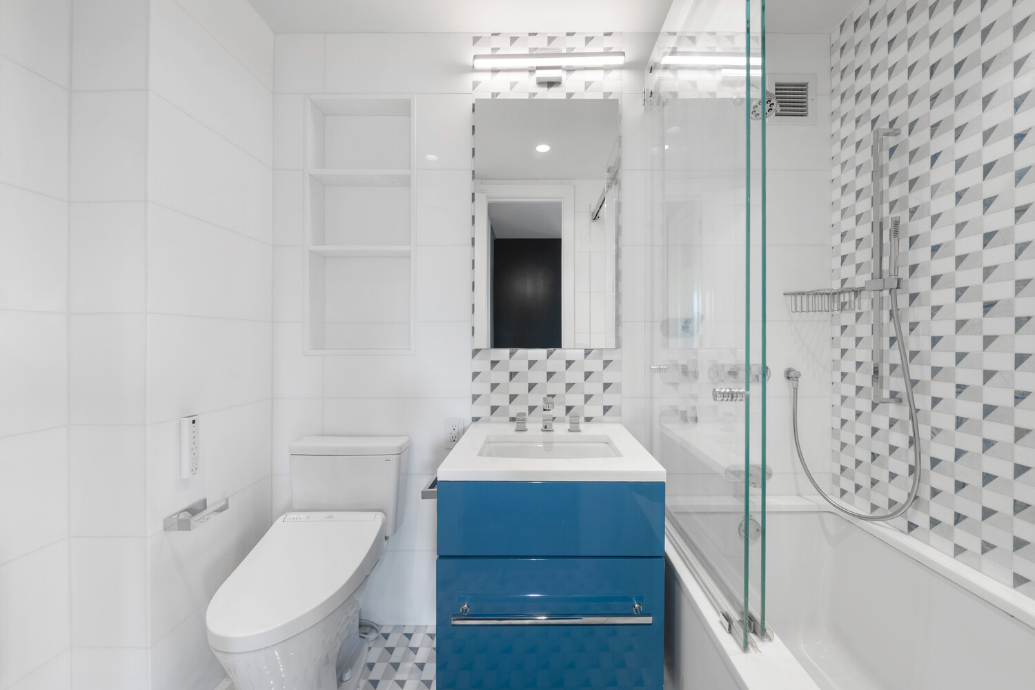 200 East 62nd Street, Unit 19D Manhattan, NY 10065 - Photo 11 of 14 a bathroom with a sink toilet and shower