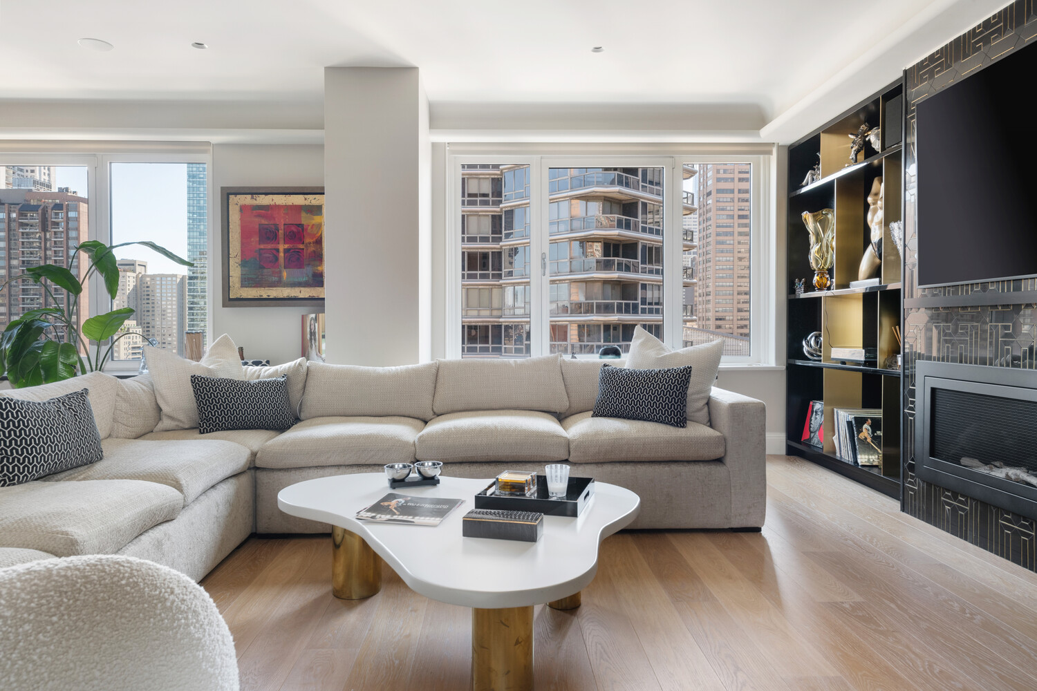 200 East 62nd Street, Unit 19D Manhattan, NY 10065 - Photo 2 of 14 a living room with furniture or couch and a flat screen tv