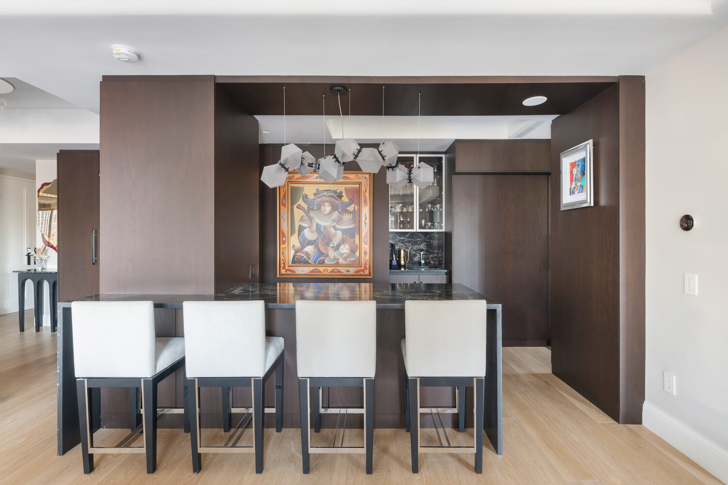200 East 62nd Street, Unit 19D Manhattan, NY 10065 - Photo 6 of 14 a kitchen with stainless steel appliances kitchen island a table and chairs in it
