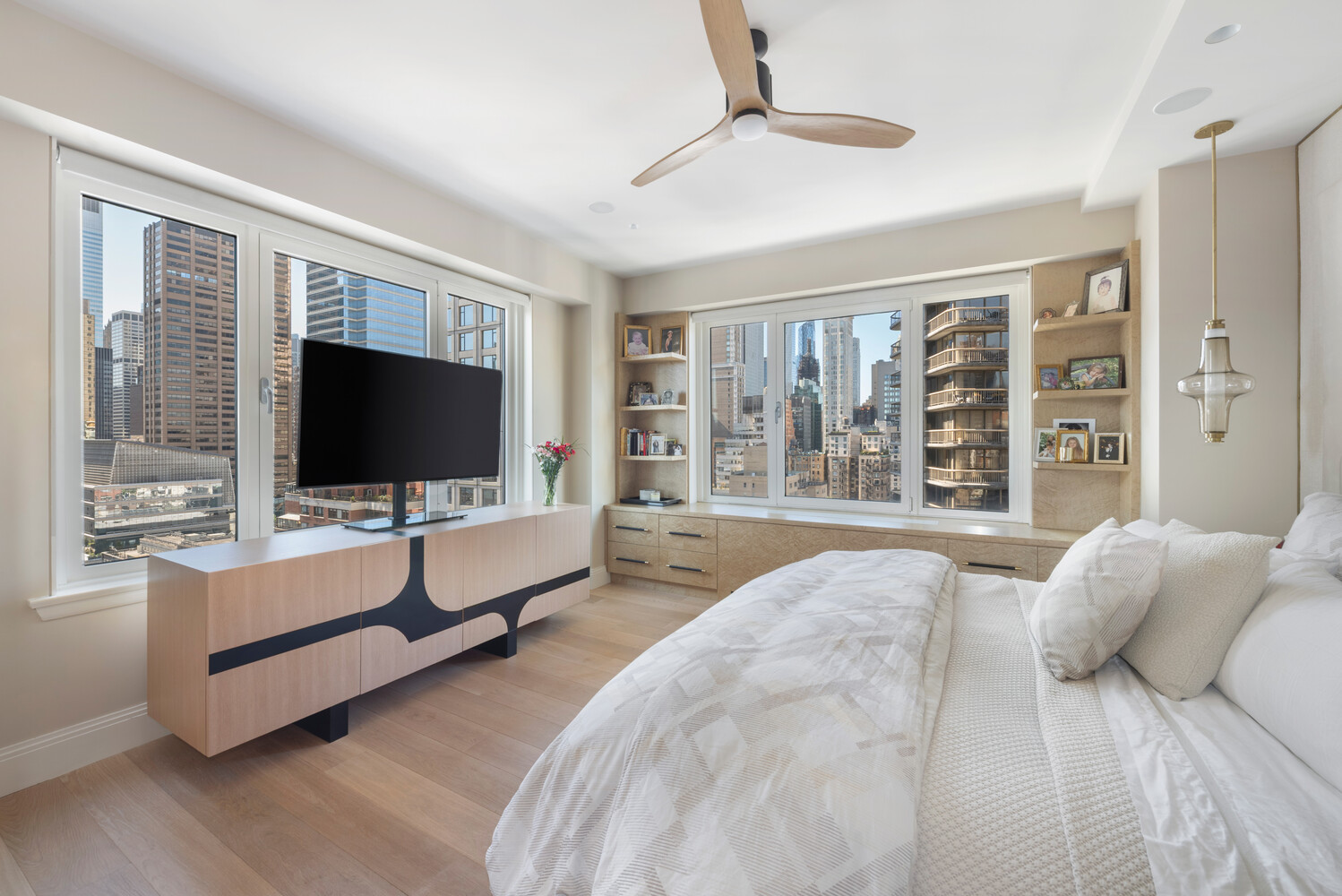 200 East 62nd Street, Unit 19D Manhattan, NY 10065 - Photo 8 of 14 a spacious bedroom with a large bed and a flat screen tv