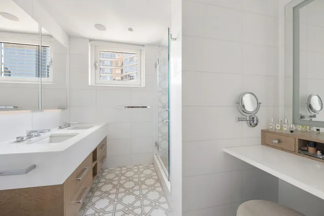 a spacious bedroom with a large bed and a flat screen tv