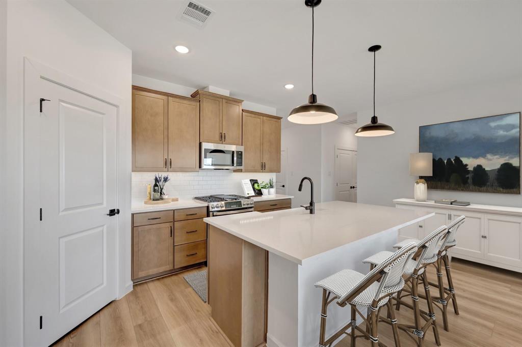 1424 Elliott Road Howe, TX 75459 - Photo 11 of 28 a kitchen with stainless steel appliances granite countertop a sink a stove a refrigerator and island