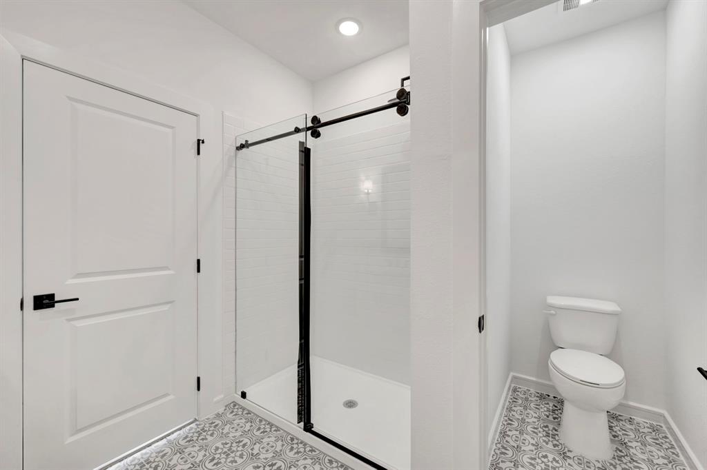 1424 Elliott Road Howe, TX 75459 - Photo 17 of 28 a bathroom with a toilet and a shower