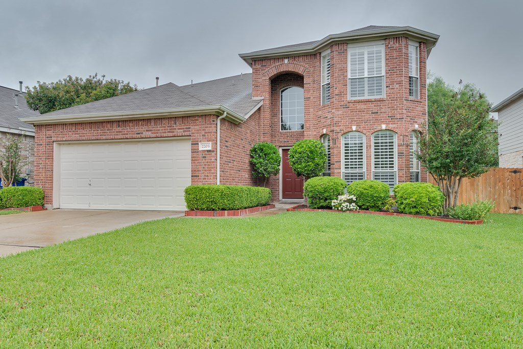 2203 Kerr Trail Cedar Park, TX 78613 - Photo 1 of 1 a front view of a house with a yard and garage