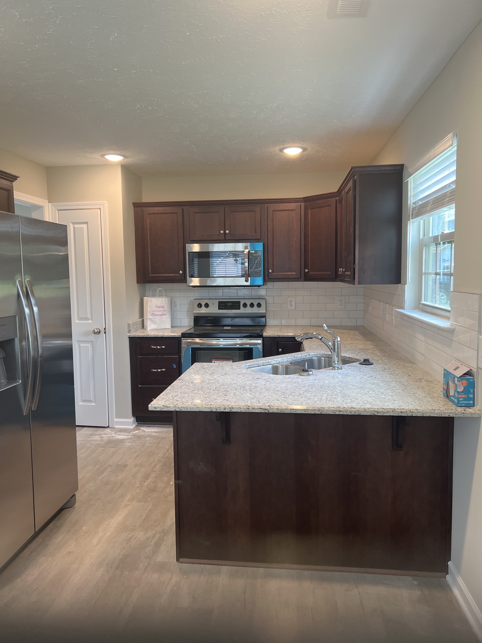 106 Timber Circle Manchester, TN 37355 - Photo 13 of 13 a kitchen with kitchen island stainless steel appliances a sink stove and refrigerator