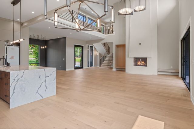 a large kitchen with stainless steel appliances lots of counter space and a sink