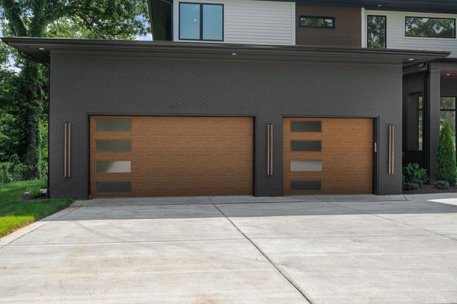 a view of a house with a big yard and large trees