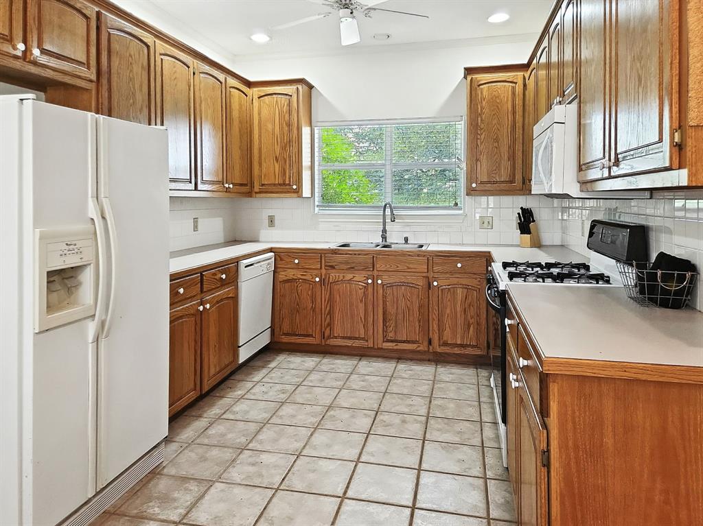 895 Pr 202 / Highway Hamilton, TX 76531 - Photo 17 of 40 a kitchen with stainless steel appliances granite countertop a sink stove and refrigerator
