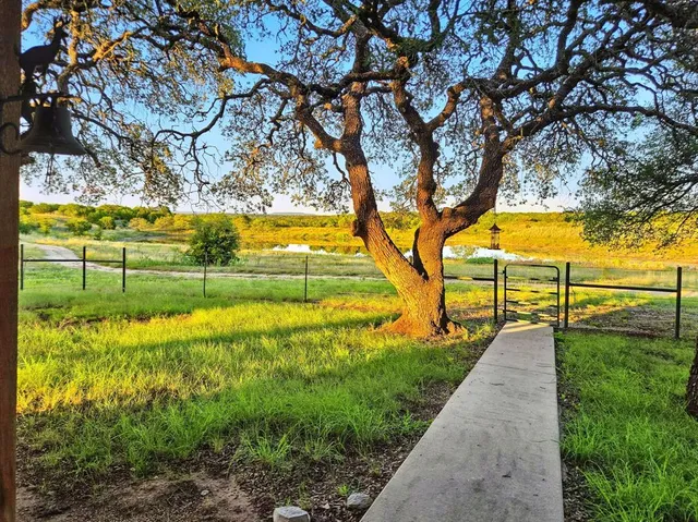 a view of yard with swimming pool and green space
