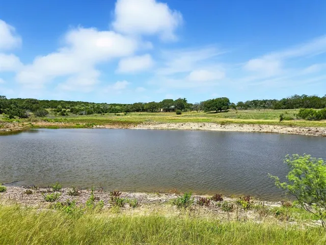 a view of a lake with houses in back