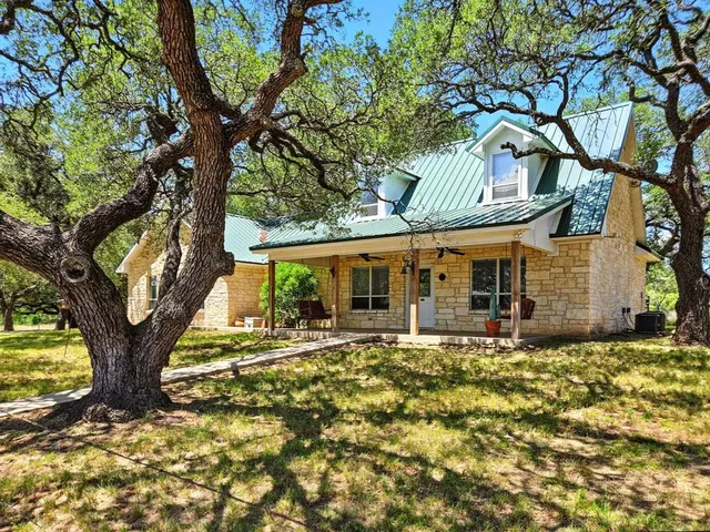 a tree in front of a white house