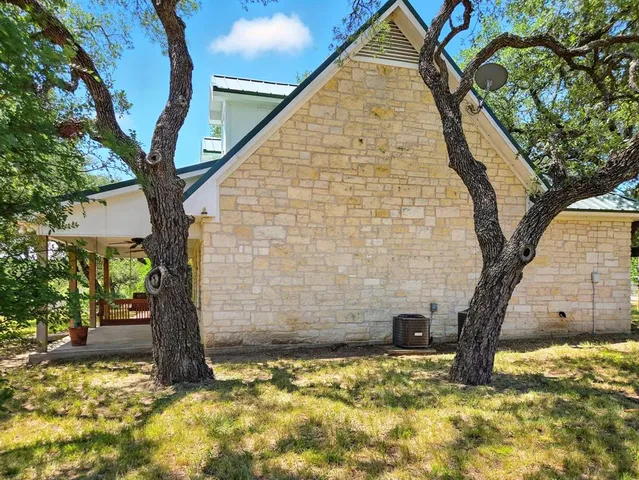 a view of a couches in the patio with a yard