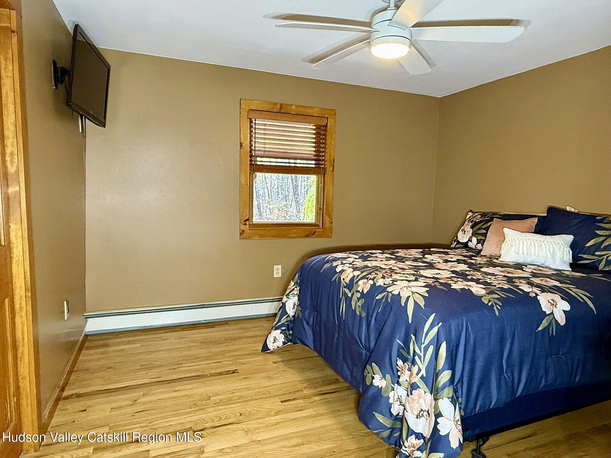 485 Potic Mountain Road Catskill, NY 12414 - Photo 11 of 46 a bedroom with a bed dresser and a window