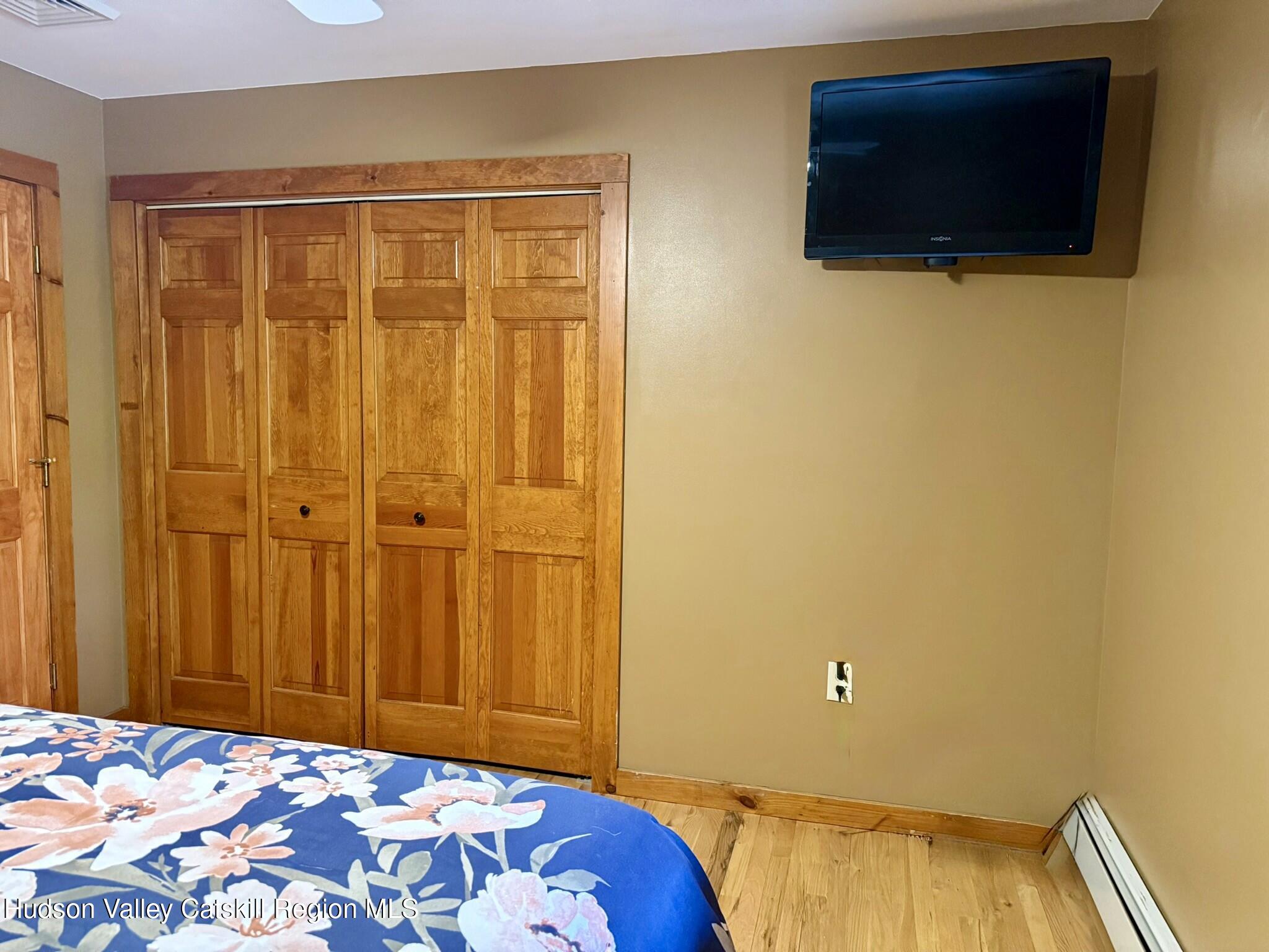 485 Potic Mountain Road Catskill, NY 12414 - Photo 13 of 46 a bedroom with a bed and a tv