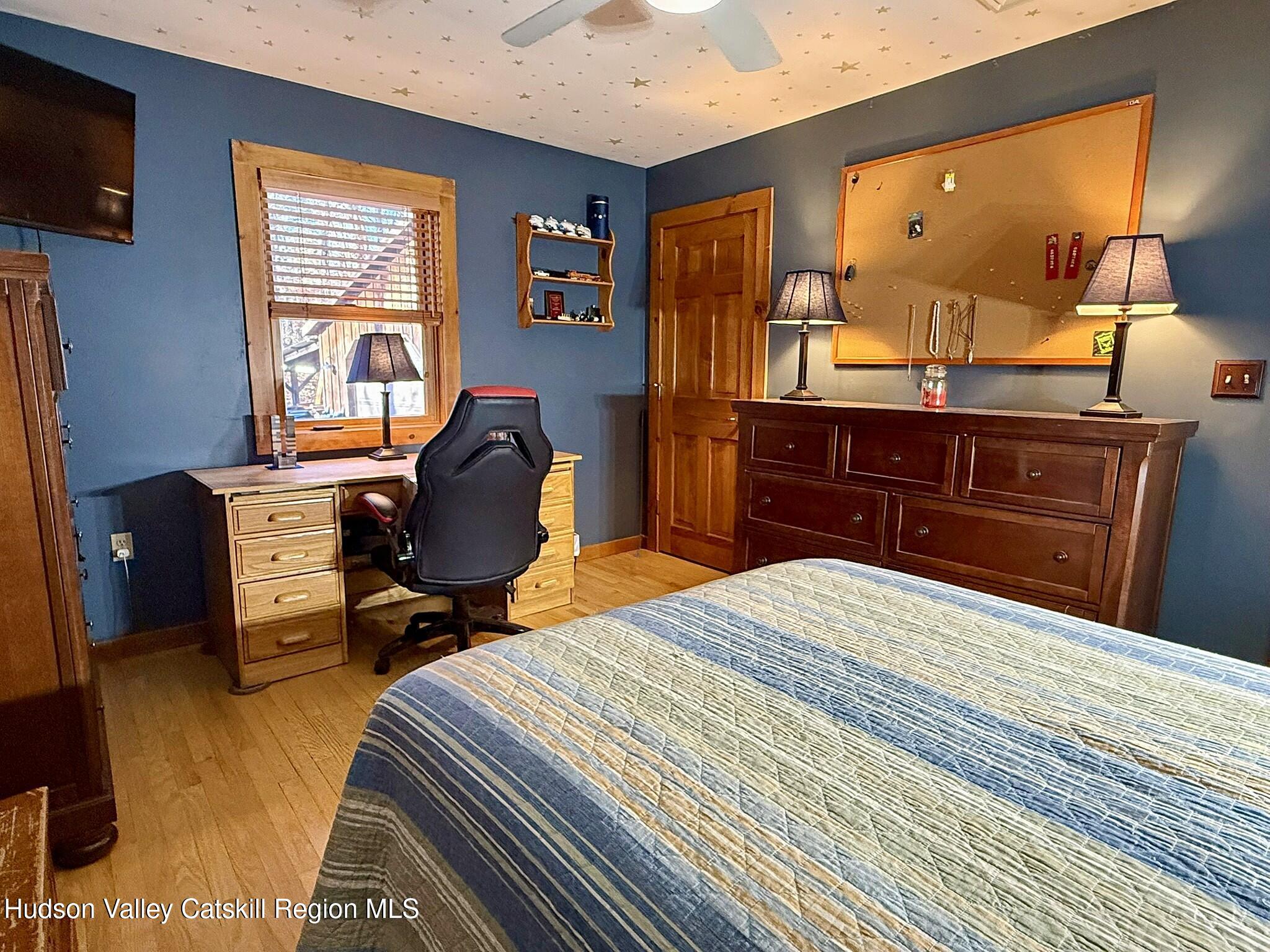 485 Potic Mountain Road Catskill, NY 12414 - Photo 17 of 46 a bedroom with a bed and wooden floor