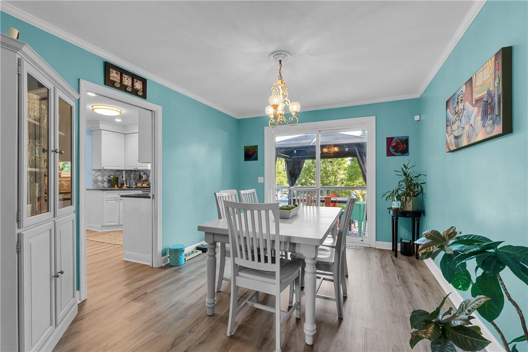 1305 Hanover Road Anderson, SC 29621 - Photo 7 of 29 Crown molding and wood-look flooring enhance this inviting dining room featuring sliding glass doors.