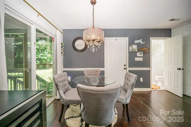 a dining room with furniture a window and wooden floor