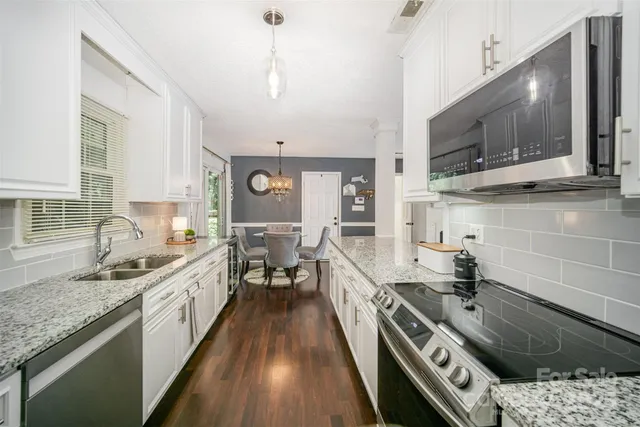 a kitchen with a sink stove and cabinets
