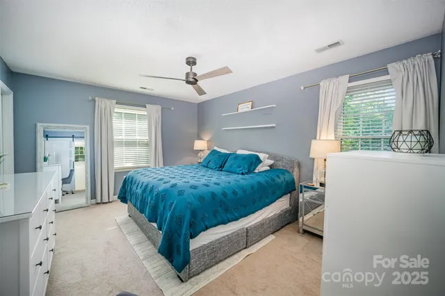 a bed room with a bed and a window