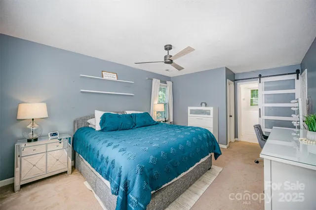 a bedroom with a bed and a lamp