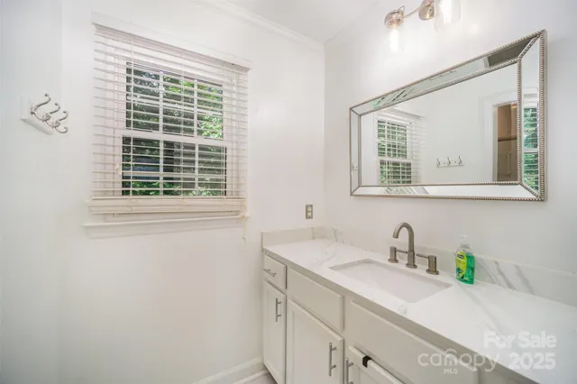 a bathroom with a sink and a window