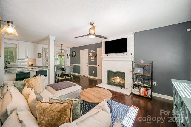 a living room with furniture a flat screen tv and a fireplace