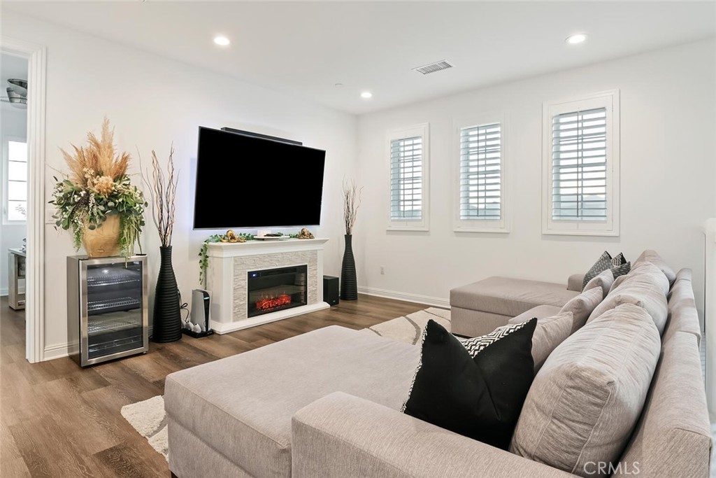 20732 Beech Circle Porter Ranch, CA 91326 - Photo 16 of 72 a living room with furniture a fireplace and a flat screen tv