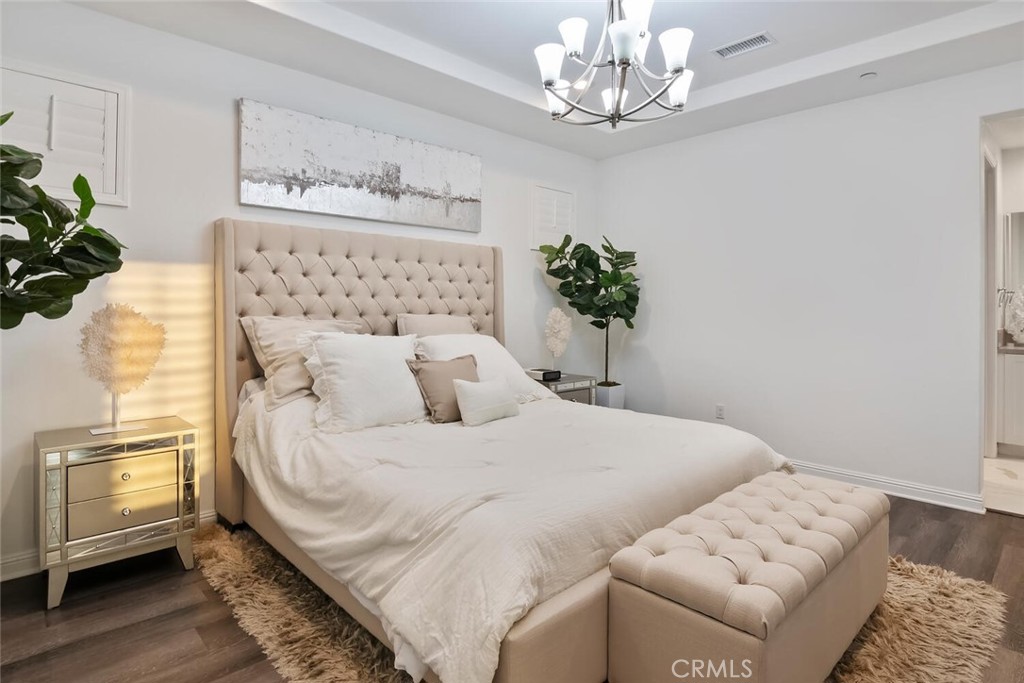 20732 Beech Circle Porter Ranch, CA 91326 - Photo 25 of 72 a bedroom with a bed and a chandelier