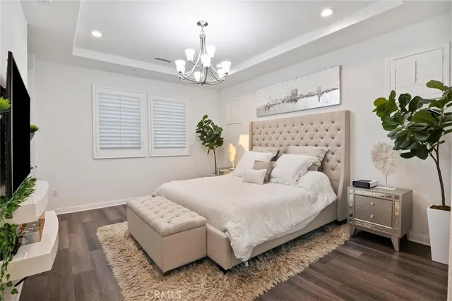 a view of a patio with table and chairs and potted plants with wooden floor and city view