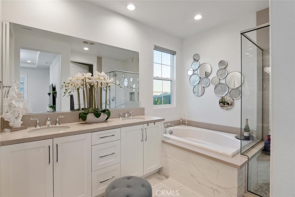 20732 Beech Circle Porter Ranch, CA 91326 - Photo 28 of 72 a bathroom with a bathtub sink and mirror